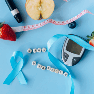 a blue background with a blue diabetes awareness ribbon, glucometer, and healthy fruits
