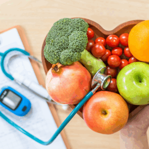 a heart-shaped bowl full of healthy fruits and vegetables with a clipboard, glucometer, and stethoscope in the background.
